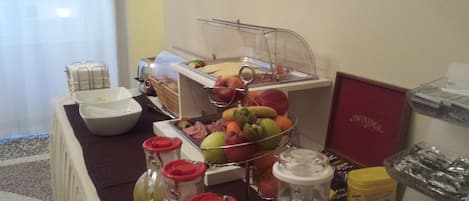 A buffet setup with various food items and condiments.