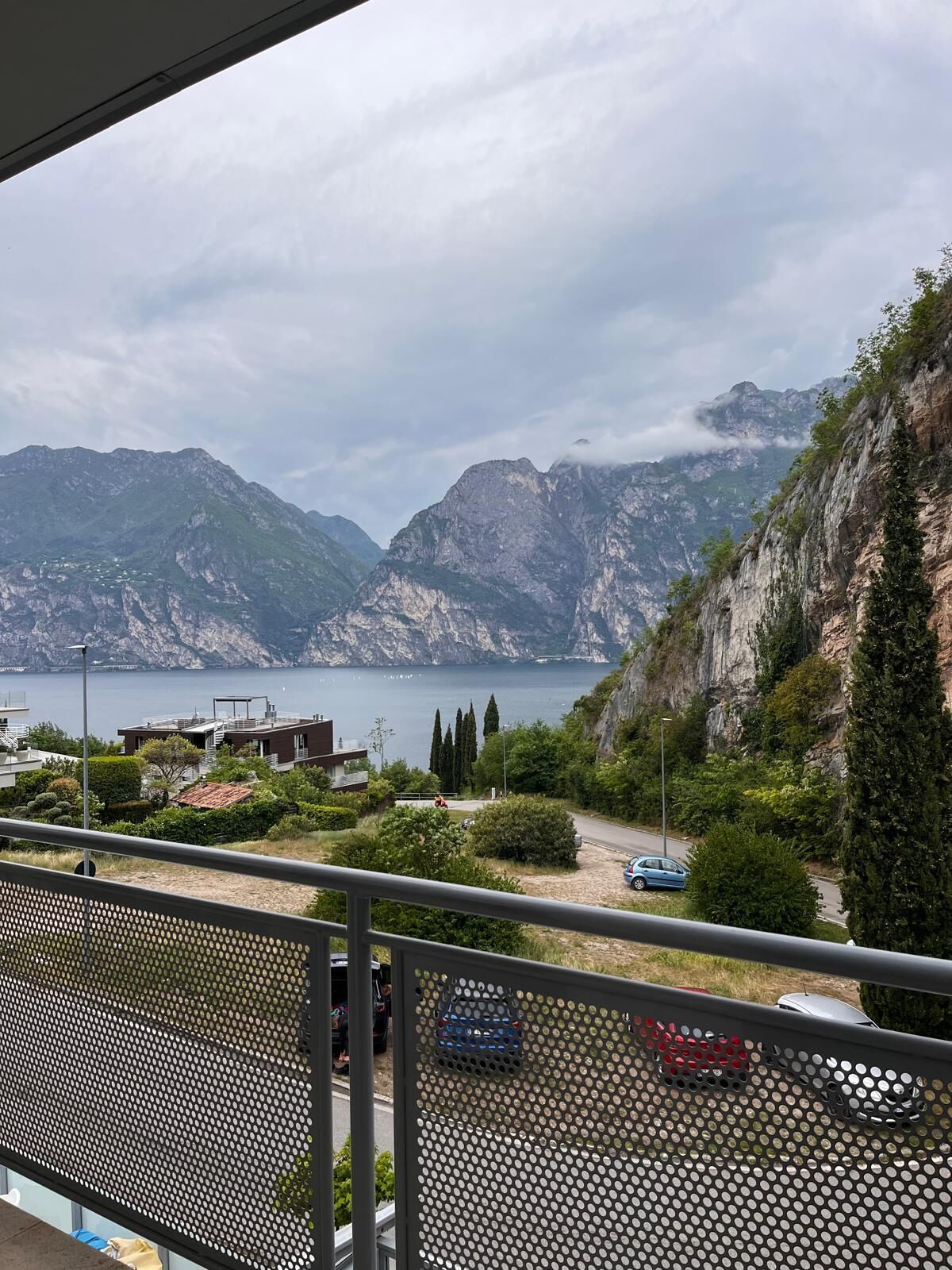 A balcony with a view of a mountainous landscape and a body of water.