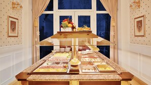 A buffet setup with various food items and a decorative centerpiece.