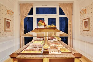 A buffet setup with various food items and a decorative centerpiece.