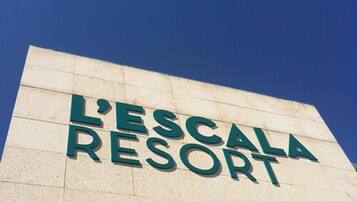 A sign for L'Escala Resort.
