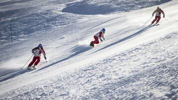 A snowy slope with skiers.