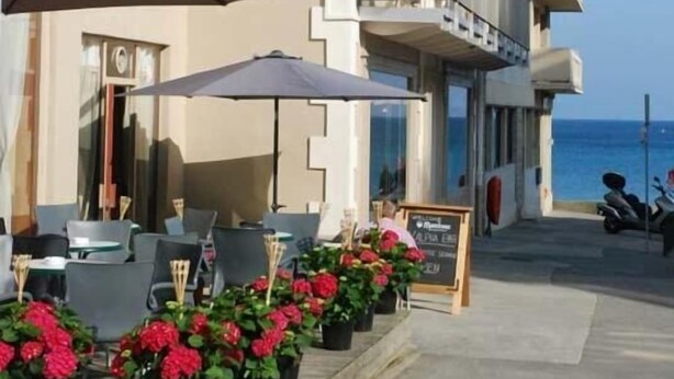 A hotel named "Hotel Alpha Ocean" with outdoor seating and potted plants. - Hotel Alpha Océan (Saint-Malo)