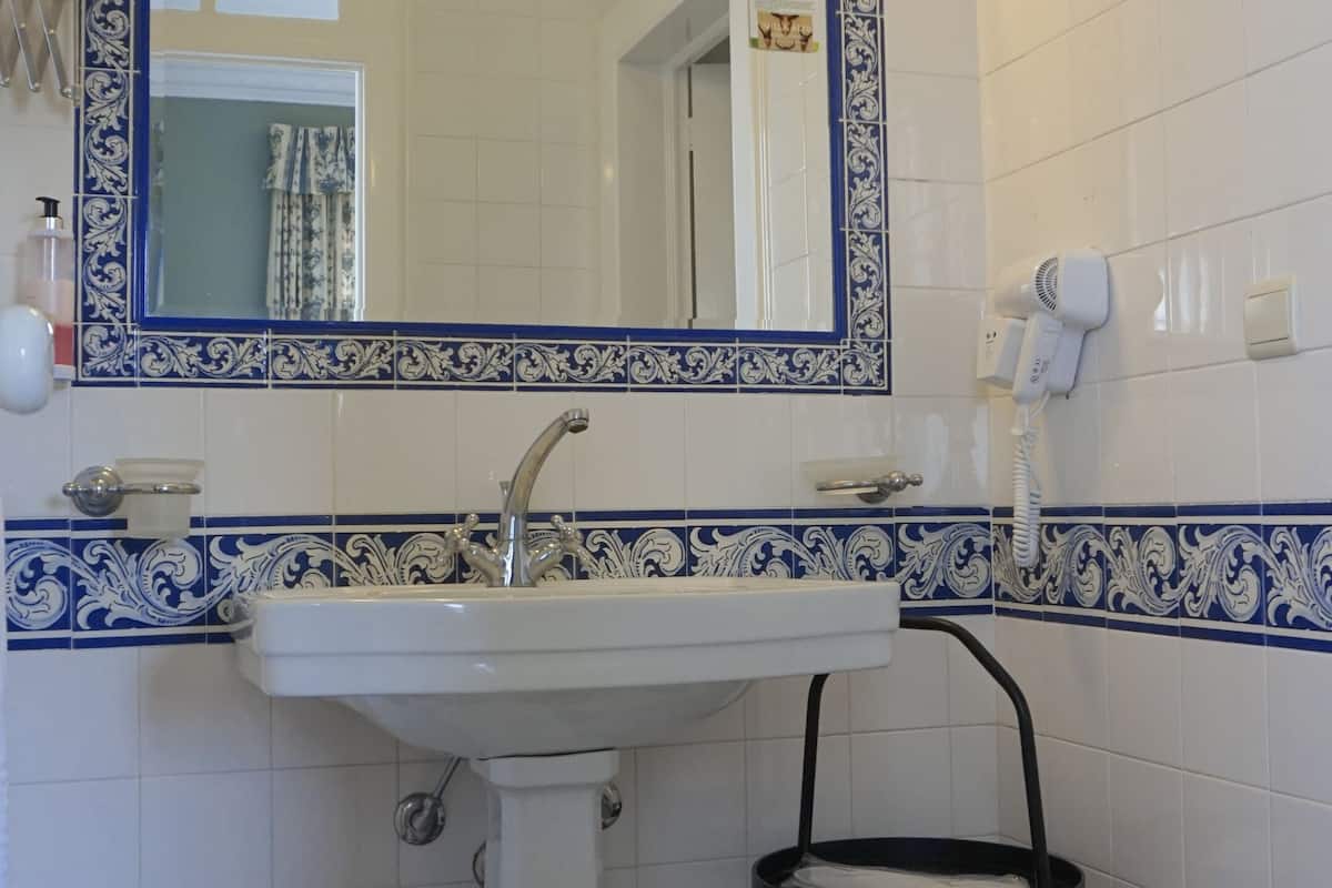 hair dryer, slippers, bidet, towels