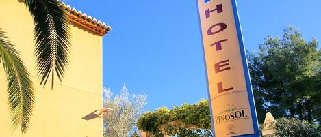 A hotel sign with "HA HOTEL" and "Pinosol" branding, indicating a hotel named Pinosol.