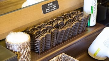 A display of hair brushes and a shaving foam canister.