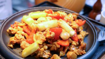 A close-up of a stir-fried dish with vegetables and meat.