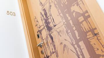 A wooden door with a number "503" and a keyhole.
