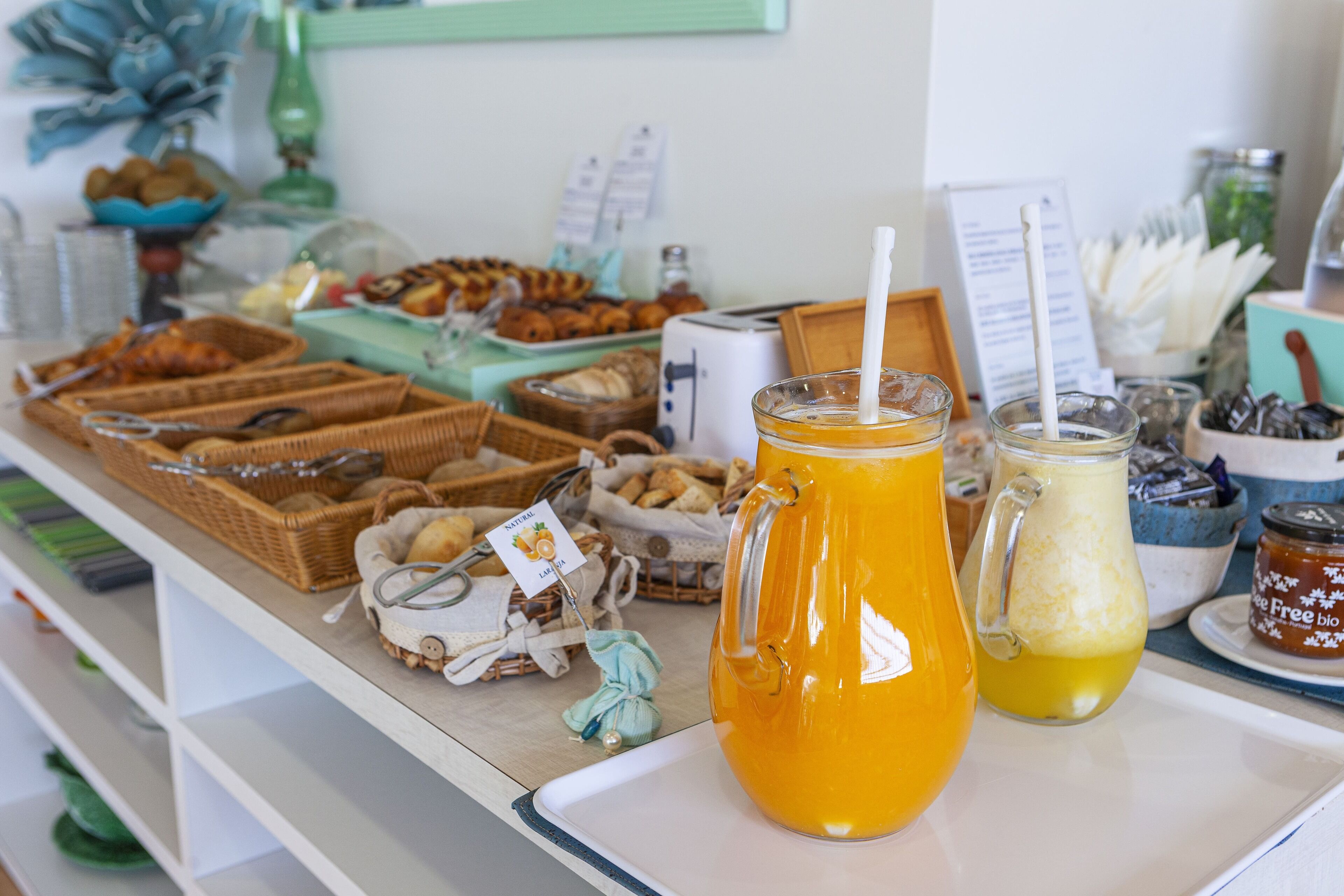 A buffet table with various food items and beverages.