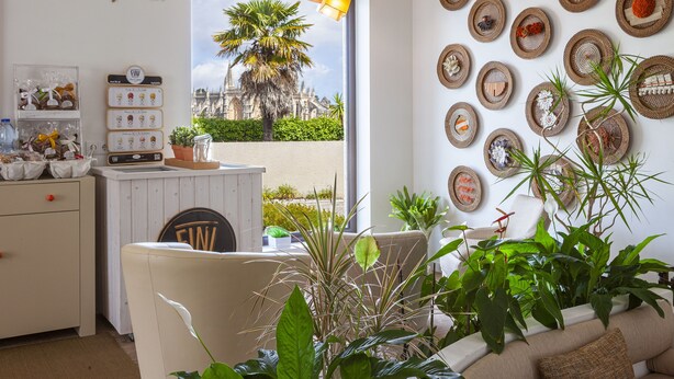 A bar area with a sign reading "Honesty Bar," a white counter with a sign, and a view of a palm tree and building through the window. - Boutique Hotel Casa do Outeiro - Arts & Crafts (Batalha)