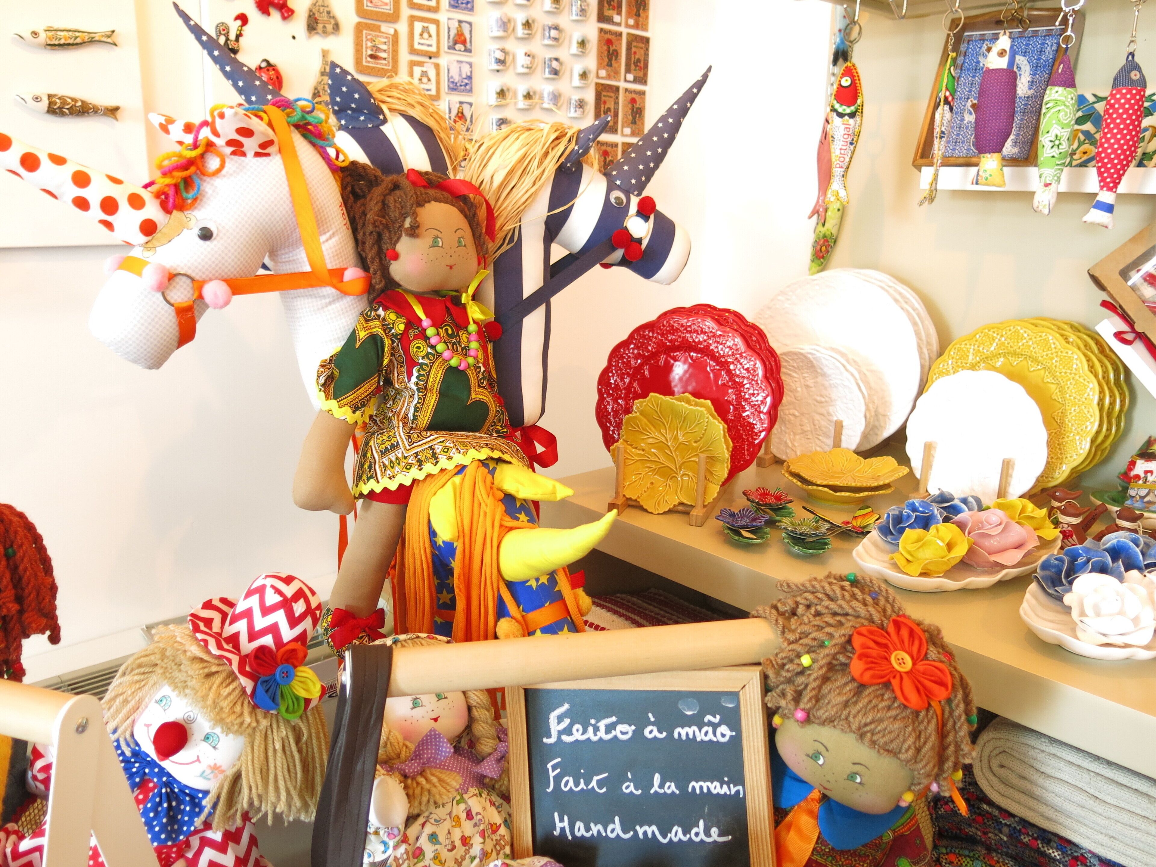 A display of handmade crafts including a unicorn, a clown, and various decorative items.