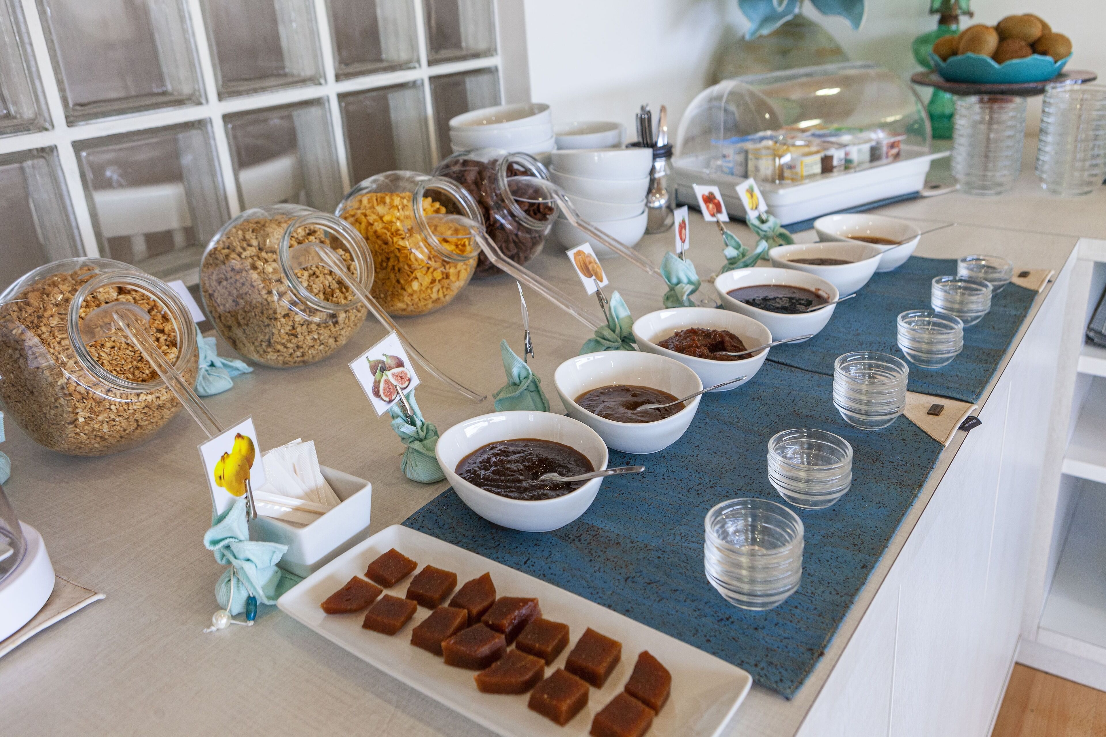 A buffet setup with various food items and serving utensils.