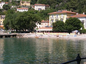 On the beach, white sand, sun loungers, beach umbrellas