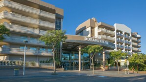 A multi-story hotel with a prominent entrance labeled "DORADA PALACE." - Ponient Dorada Palace by PortAventura World (Salou)