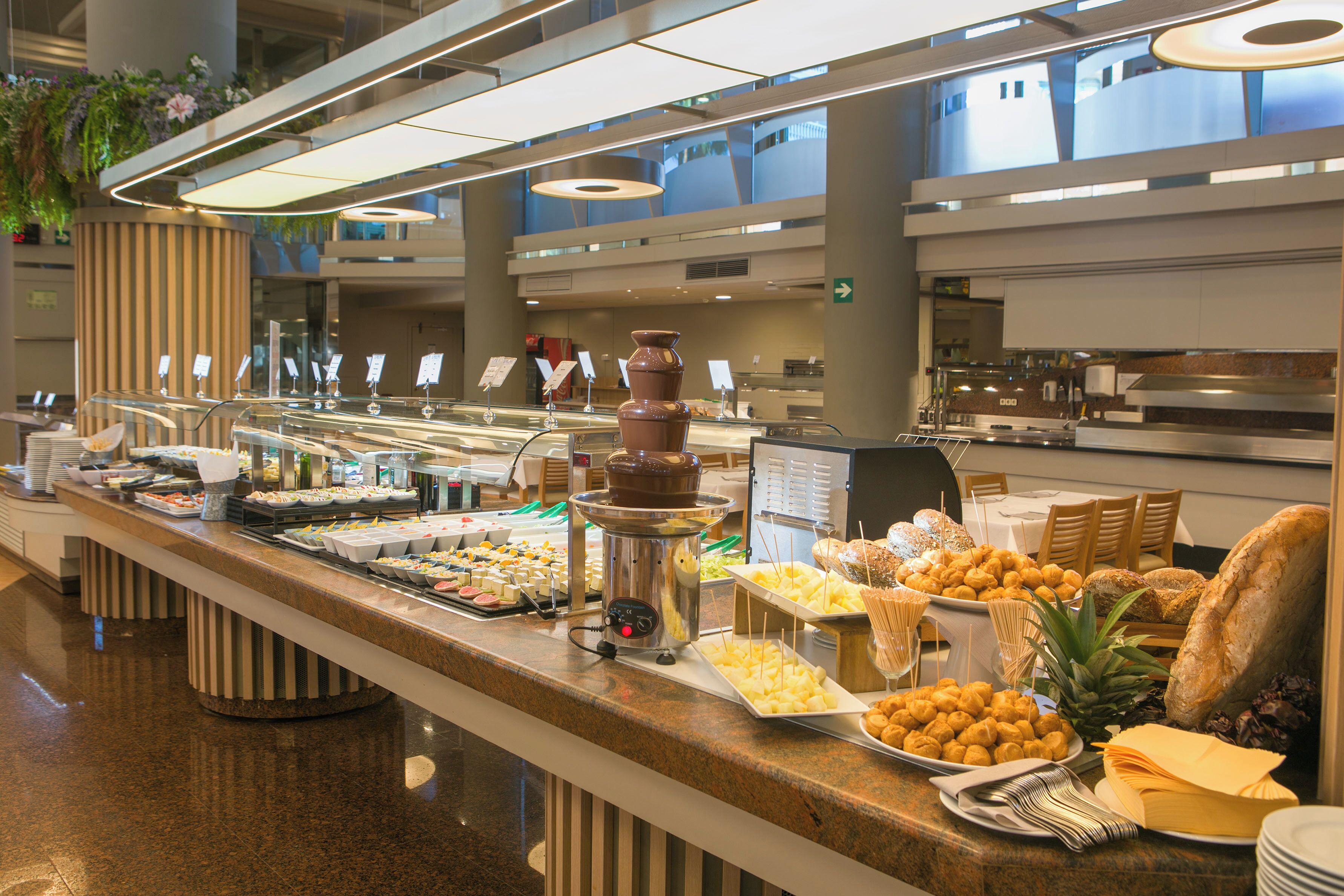 A buffet with various food items and a hot chocolate station.