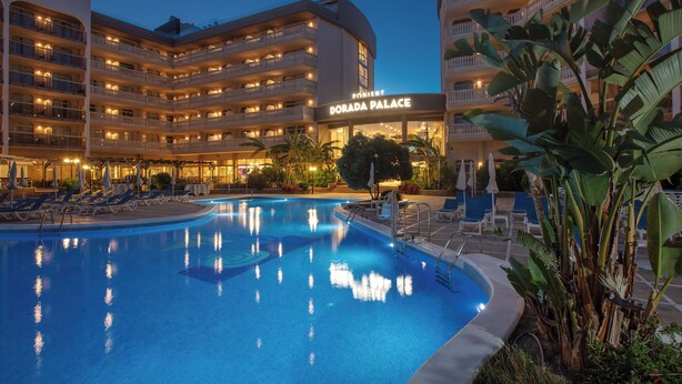A hotel with a swimming pool, multiple balconies, and a sign reading "Dorada Palace". - Ponient Dorada Palace by PortAventura World (Salou)