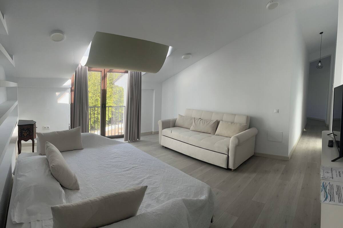 family suite, multiple beds | living area | plasma tv