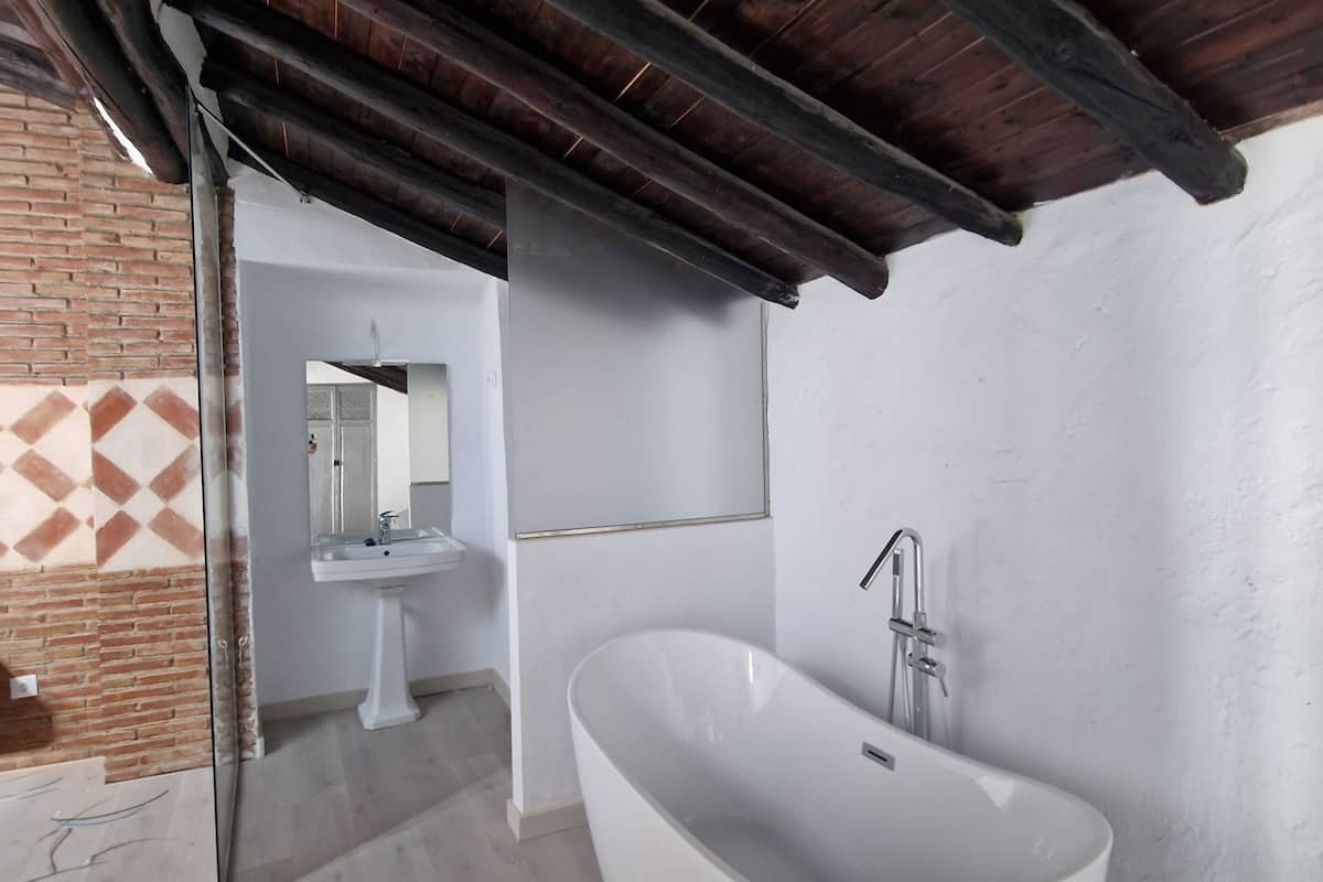 deluxe suite, multiple beds | bathroom | hair dryer, towels, soap, toilet paper