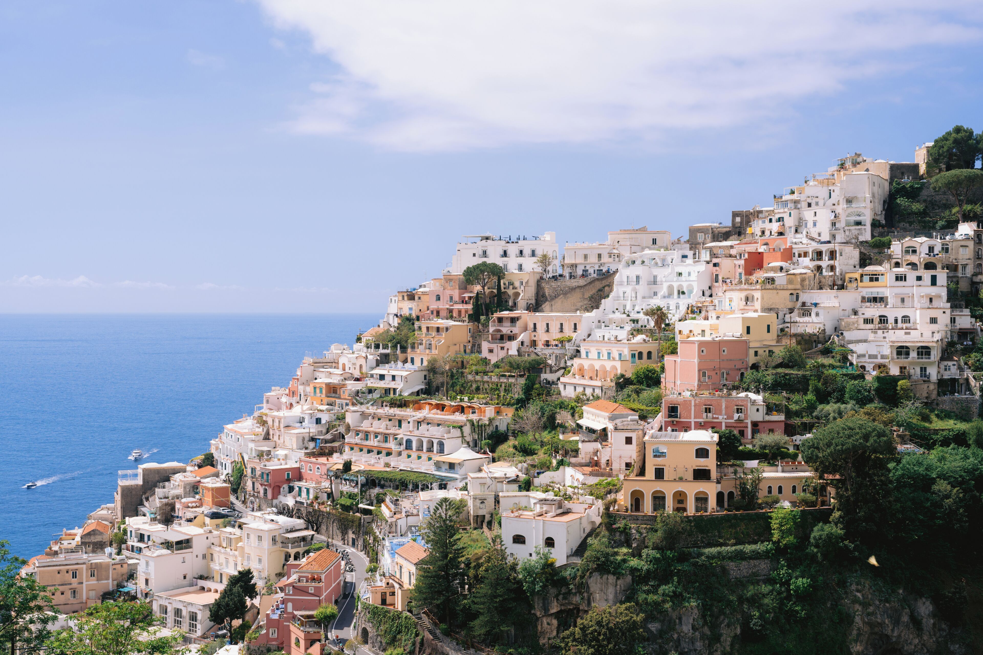 A coastal town with buildings built on a hillside overlooking the sea.