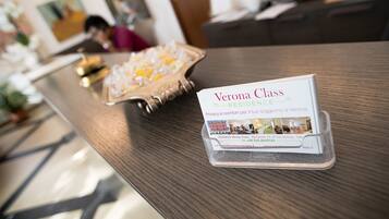 A reception desk with a brochure for Verona Class Residence.