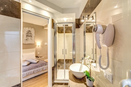 Shower, free toiletries, hair dryer, slippers. The Bridge Suites