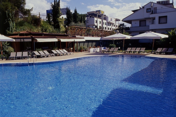 Outdoor pool, open 10:00 AM to 7:00 PM, pool umbrellas, pool loungers