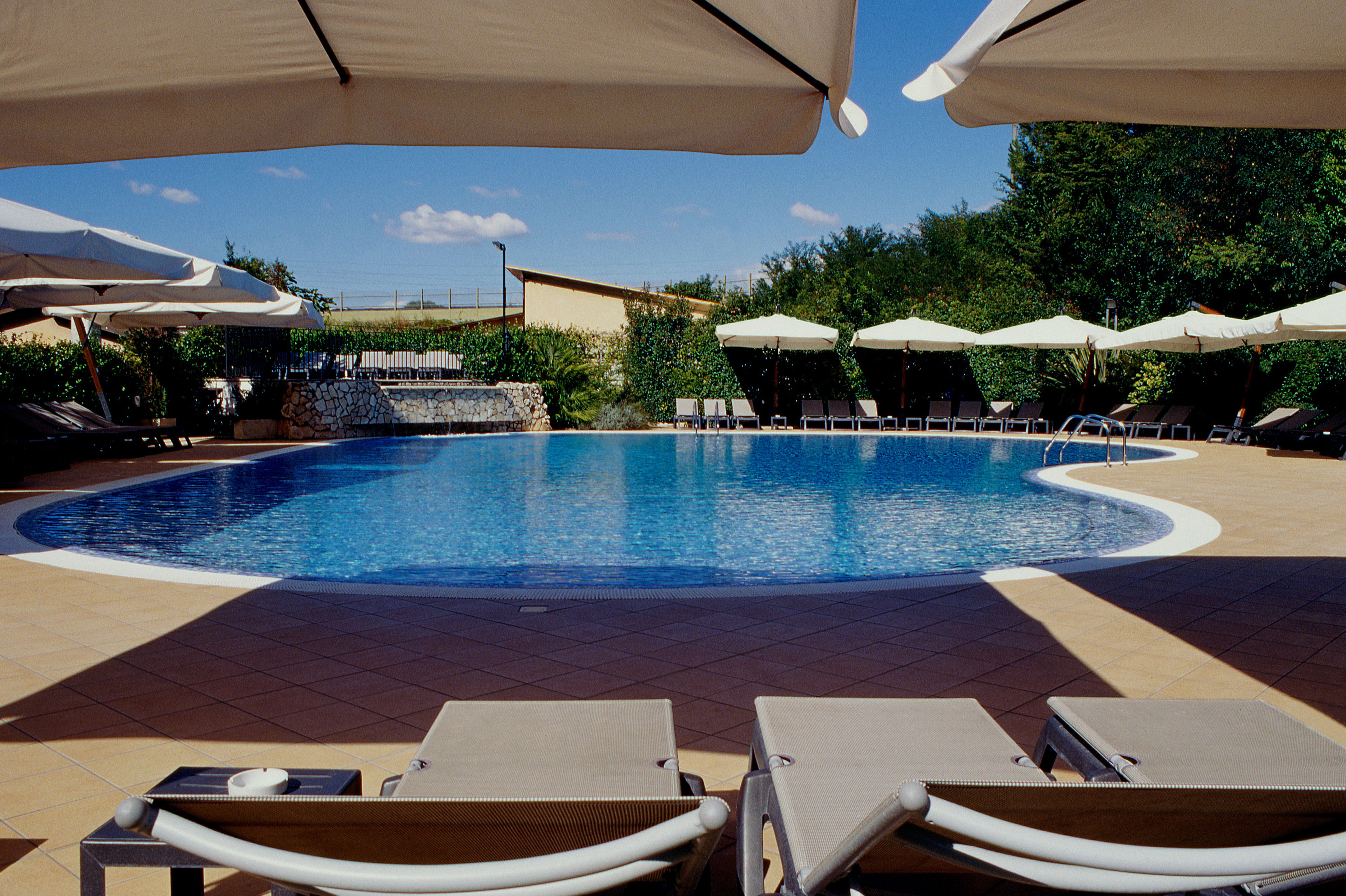 Outdoor pool, open 10:00 AM to 7:00 PM, pool umbrellas, pool loungers