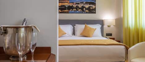 A hotel room with a bed, a nightstand, a lamp, a large painting of a cityscape, and a view of a yellow curtain.
