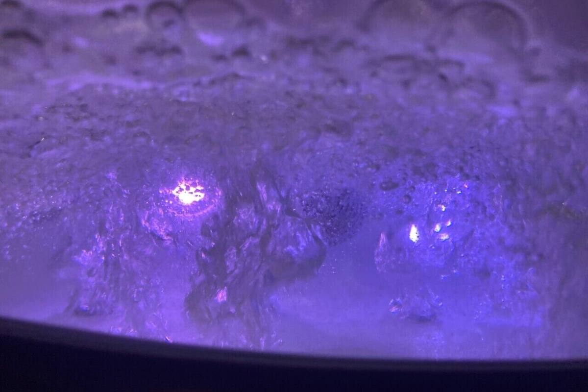 A close-up of a textured surface with a purple hue, possibly a part of a room's decor or furniture.