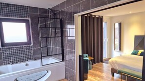 A modern bathroom with a bathtub, a shower, and a vanity. - Hôtel des Argousiers (Ambleteuse)