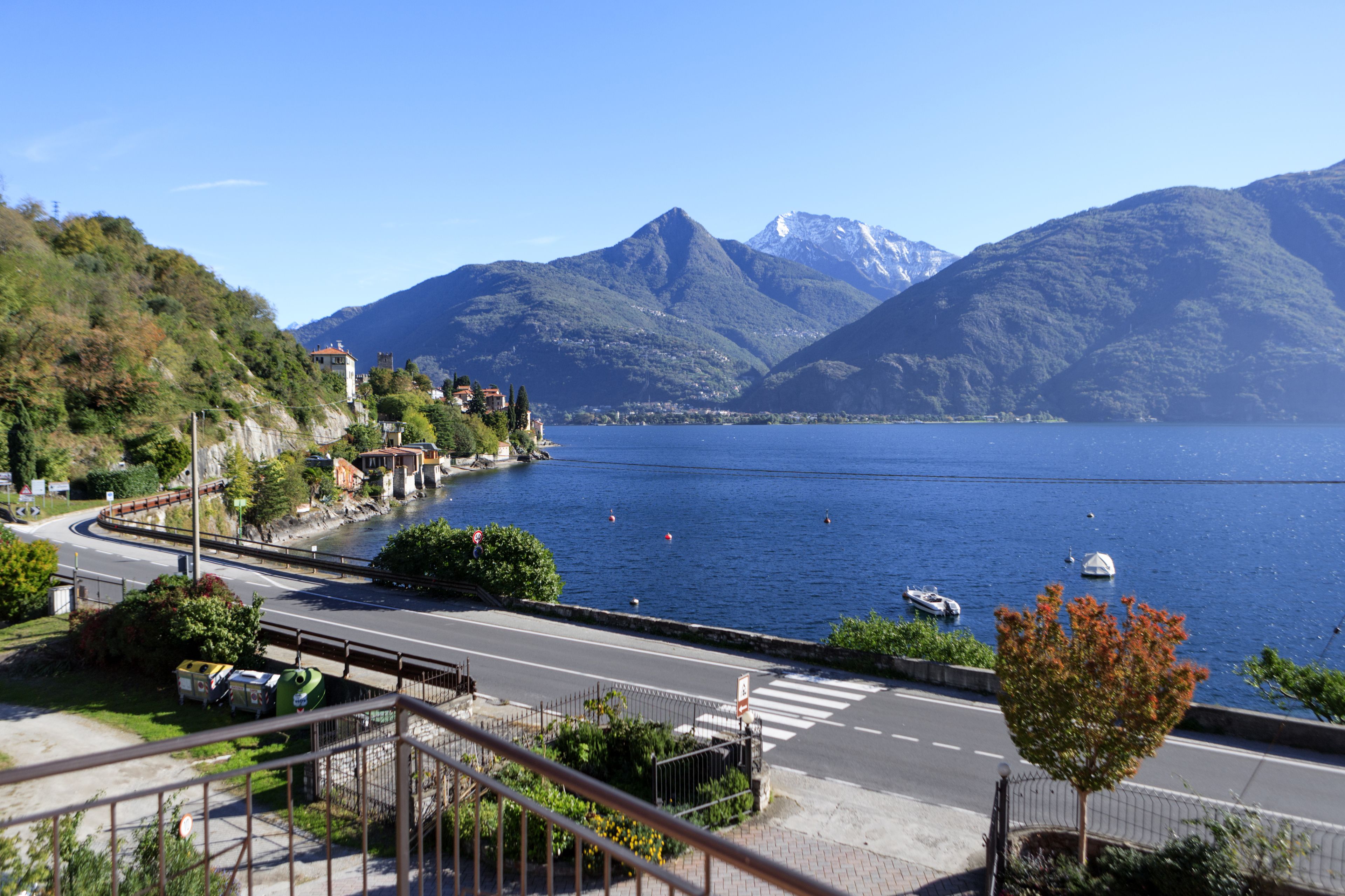 A coastal road with a view of a lake and mountains.