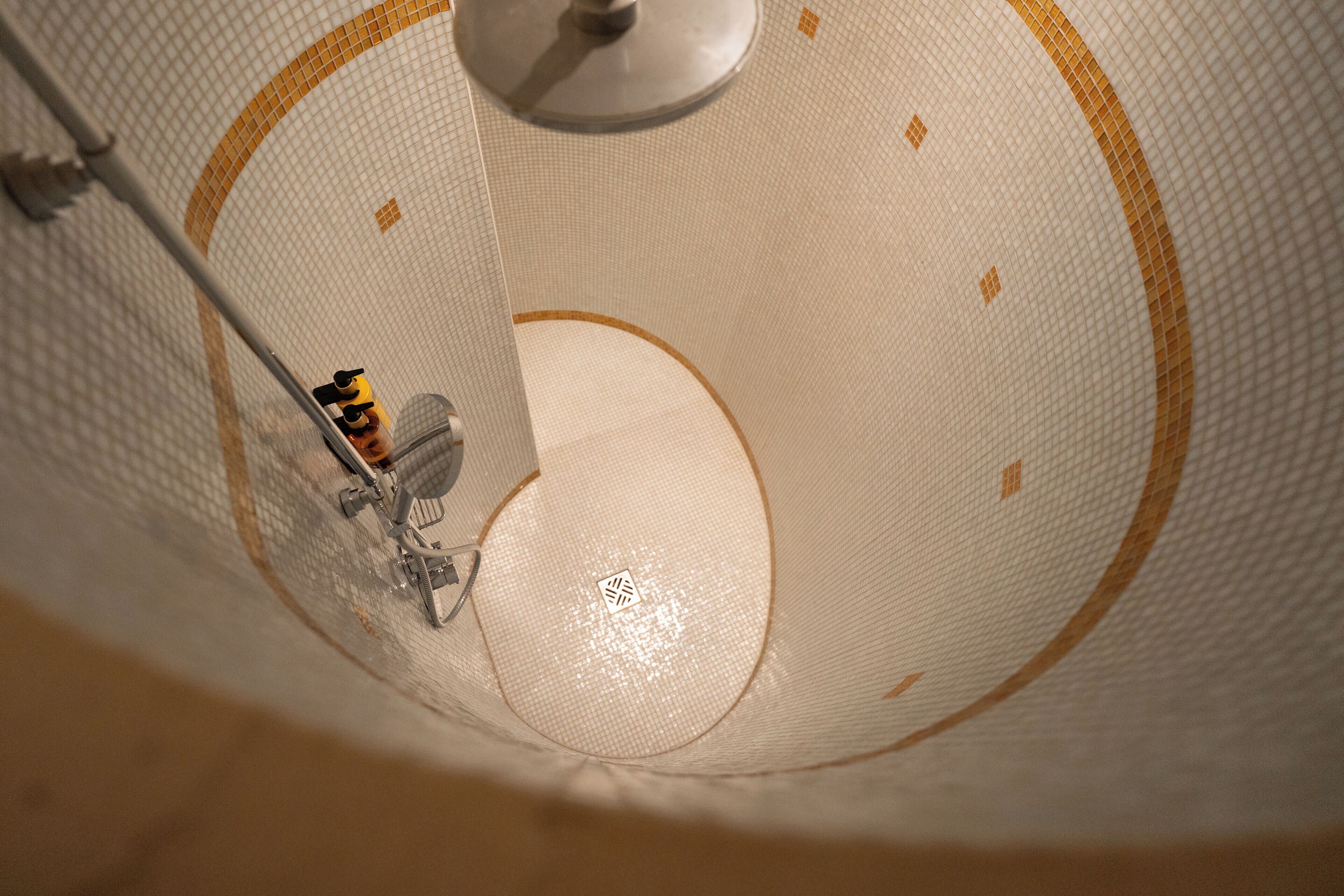 A close-up of a textured ceiling with a circular design and a central light fixture.