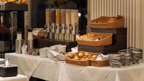 A buffet setup with various food items and serving utensils. - Aqua Aurelia Suitenhotel an den Thermen (Baden-Baden)