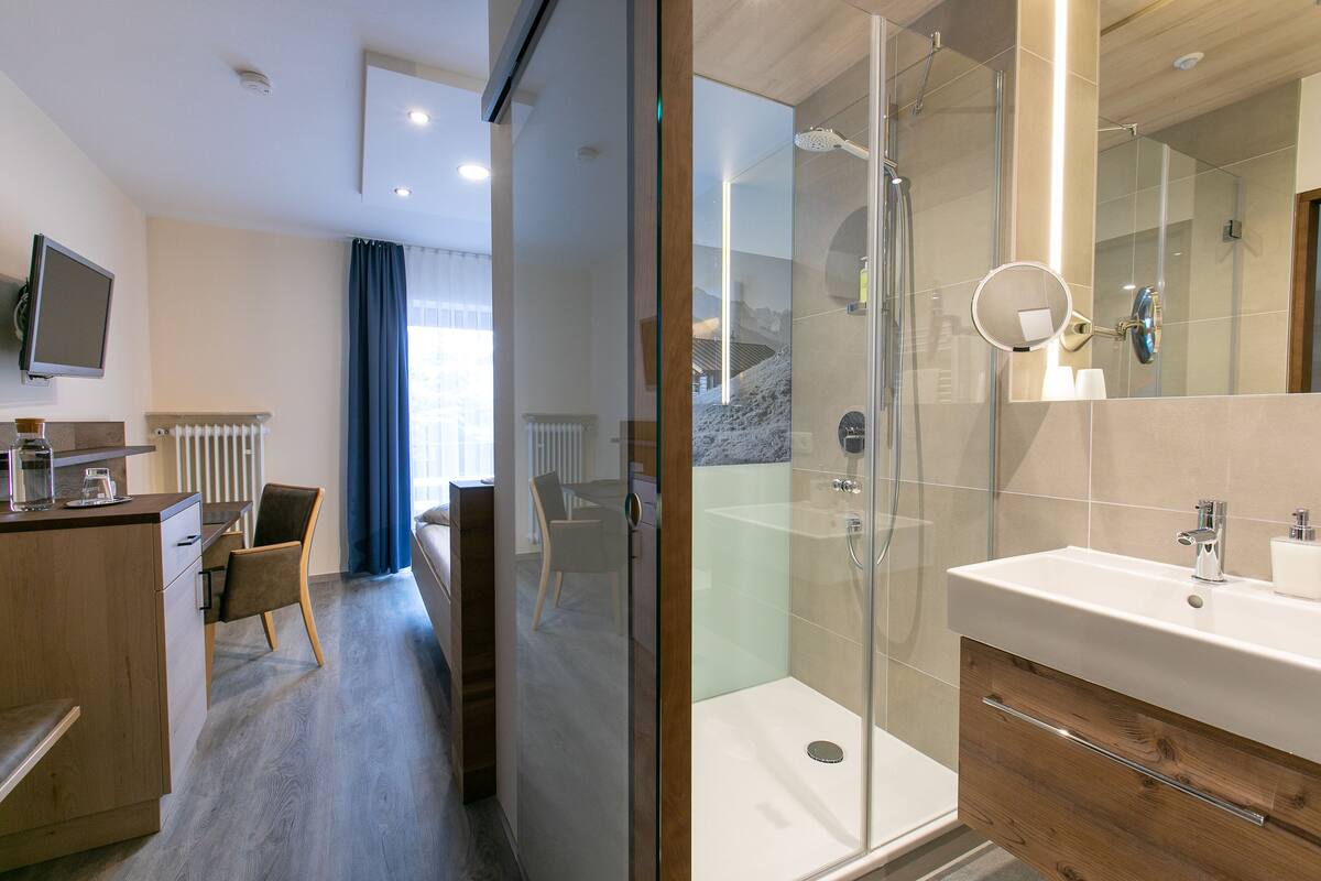 traditional single room | bathroom | shower, hair dryer, towels, soap