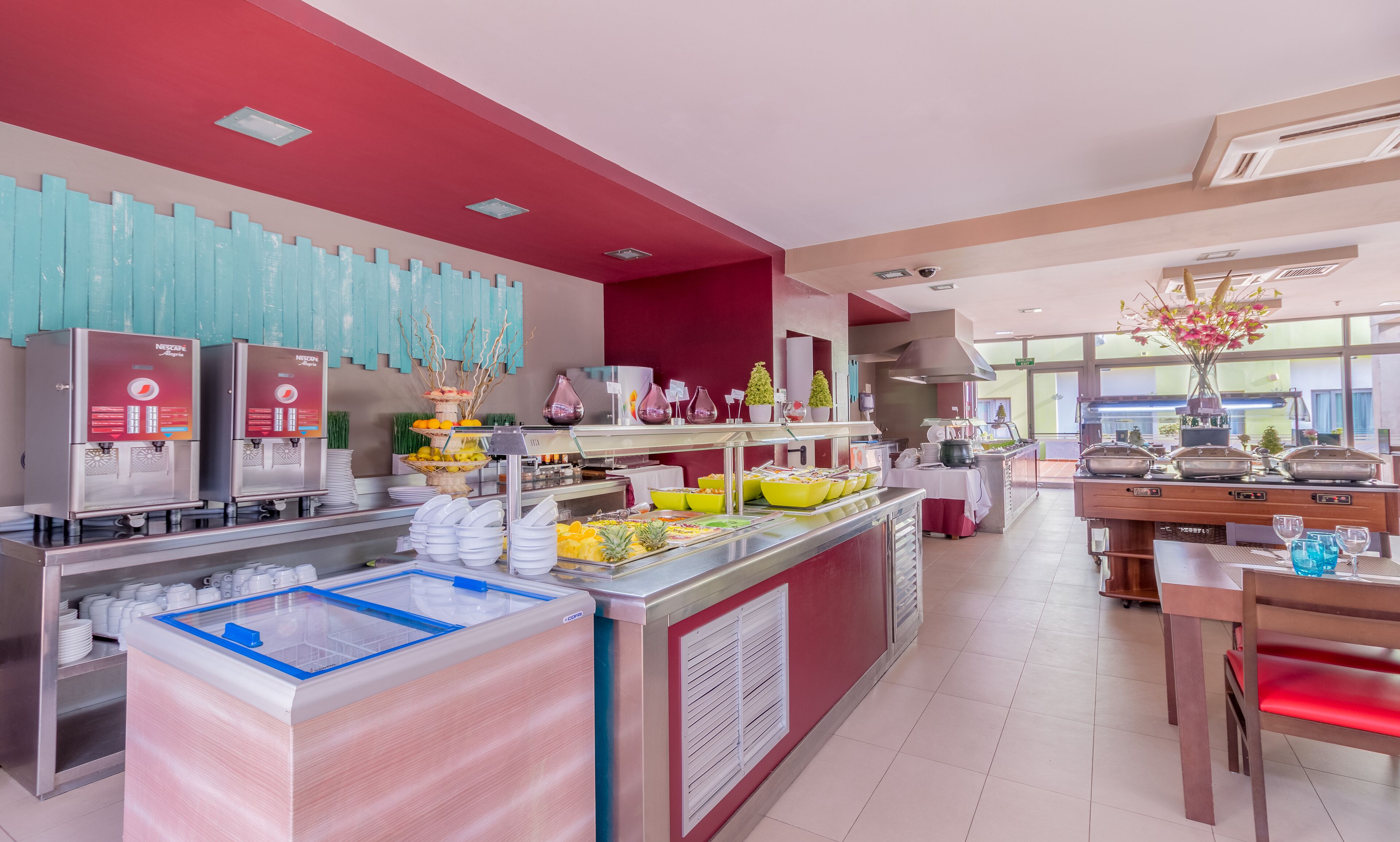 A modern breakfast buffet with a variety of food options, a coffee station, and a seating area with a view.