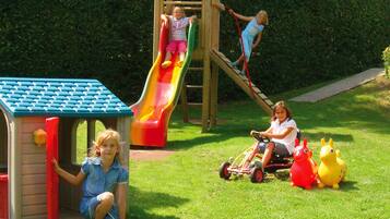 A playground with a slide and climbing structure.