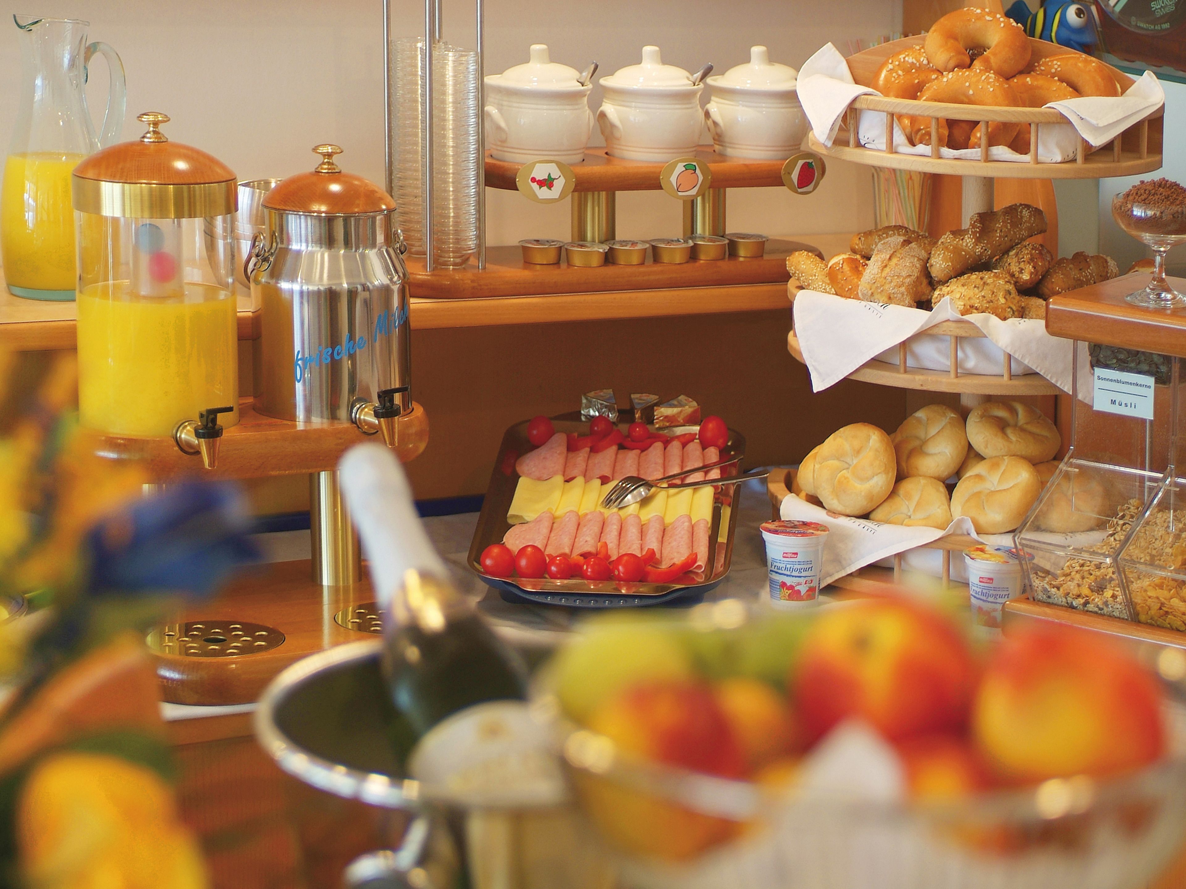 A breakfast buffet with various food items and beverages.