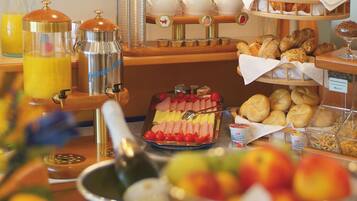 A breakfast buffet with various food items and beverages.