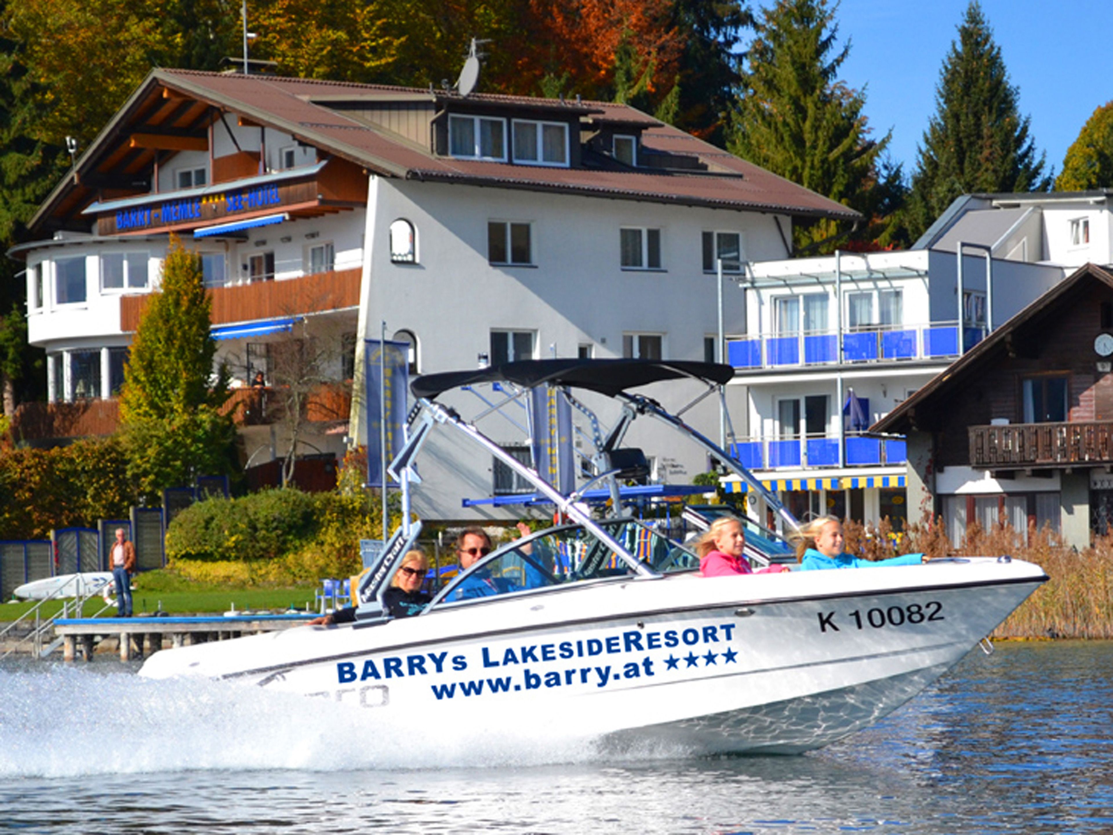 A boat with "Barry's Lakeside Resort" and a website URL on its side.