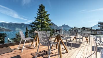 Enjoy the serene views of the water and surrounding mountains from this outdoor space.