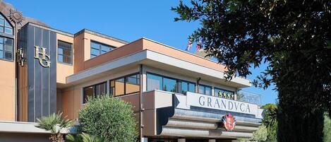 A hotel with a prominent sign reading 'GRANDVCA'.