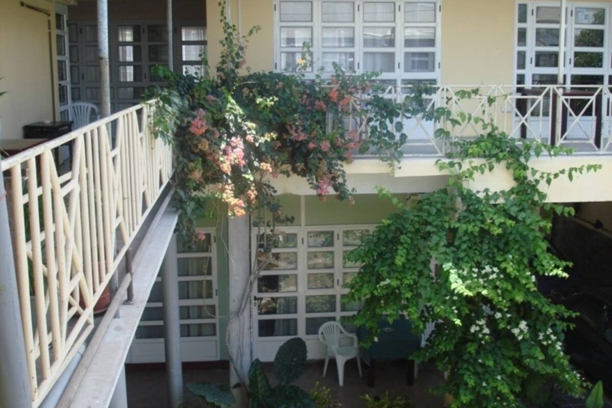 A multi-level building with balconies, railings, and windows.