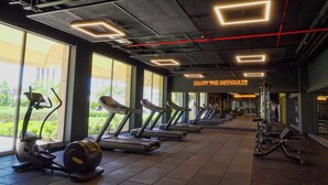 A gym with treadmills, elliptical machines, and weight equipment. - Kefaluka Resort - All Inclusive (Bodrum)
