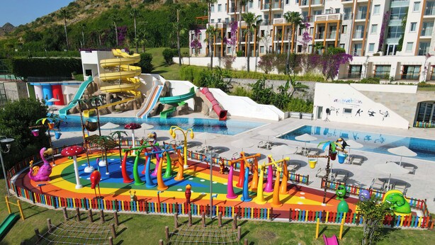 A water park with slides, a wave pool, and a playground area. - Kefaluka Resort - All Inclusive (Bodrum)