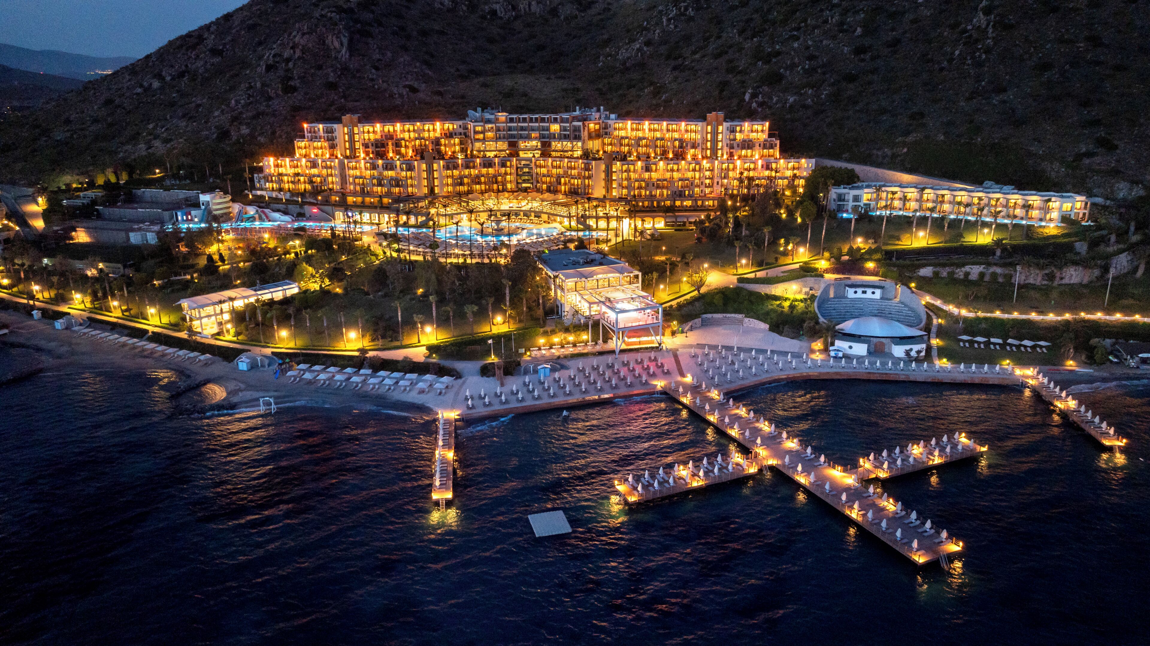 A large resort with multiple buildings, a marina, and a beach area.