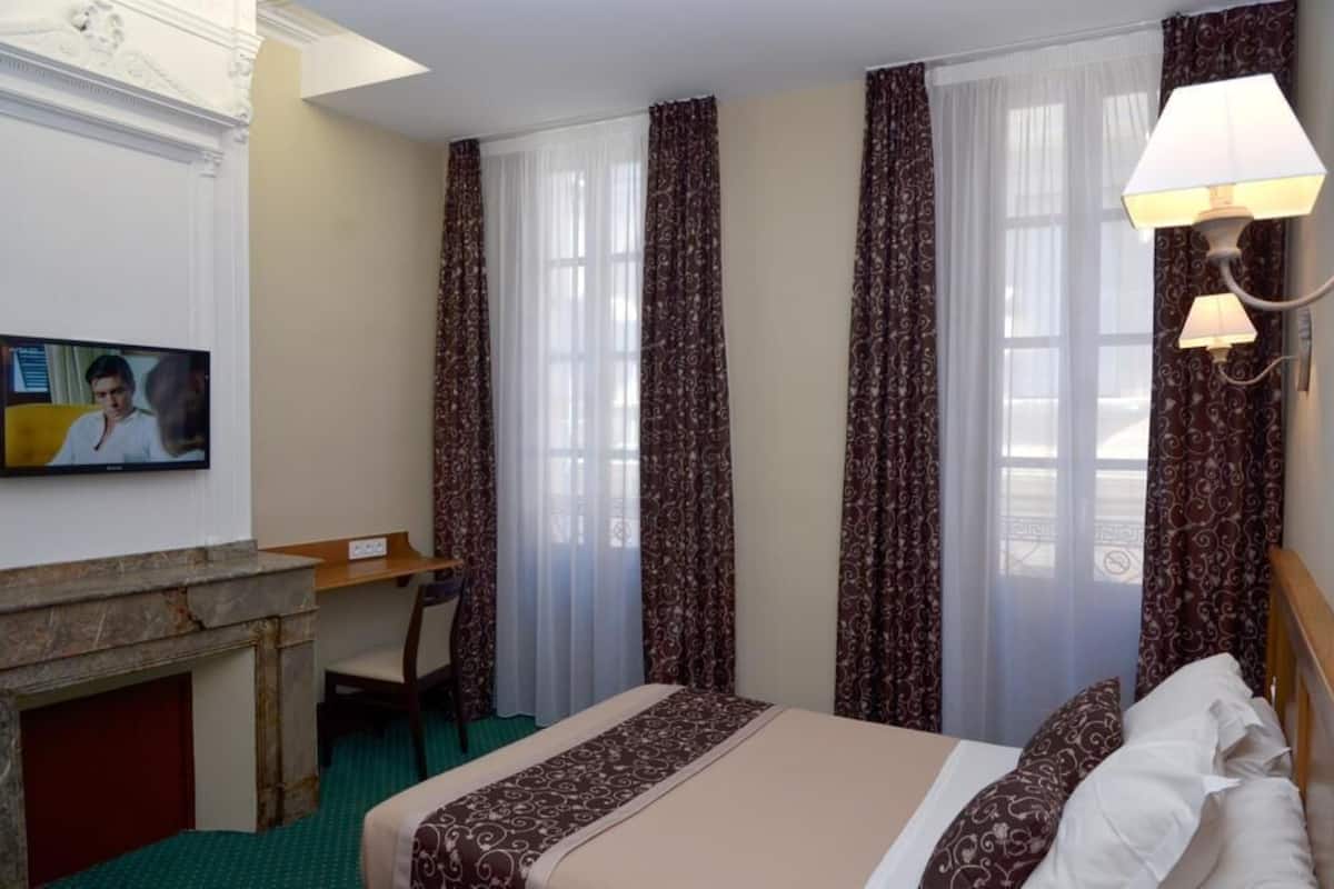 Premium bedding, desk, laptop workspace, blackout drapes