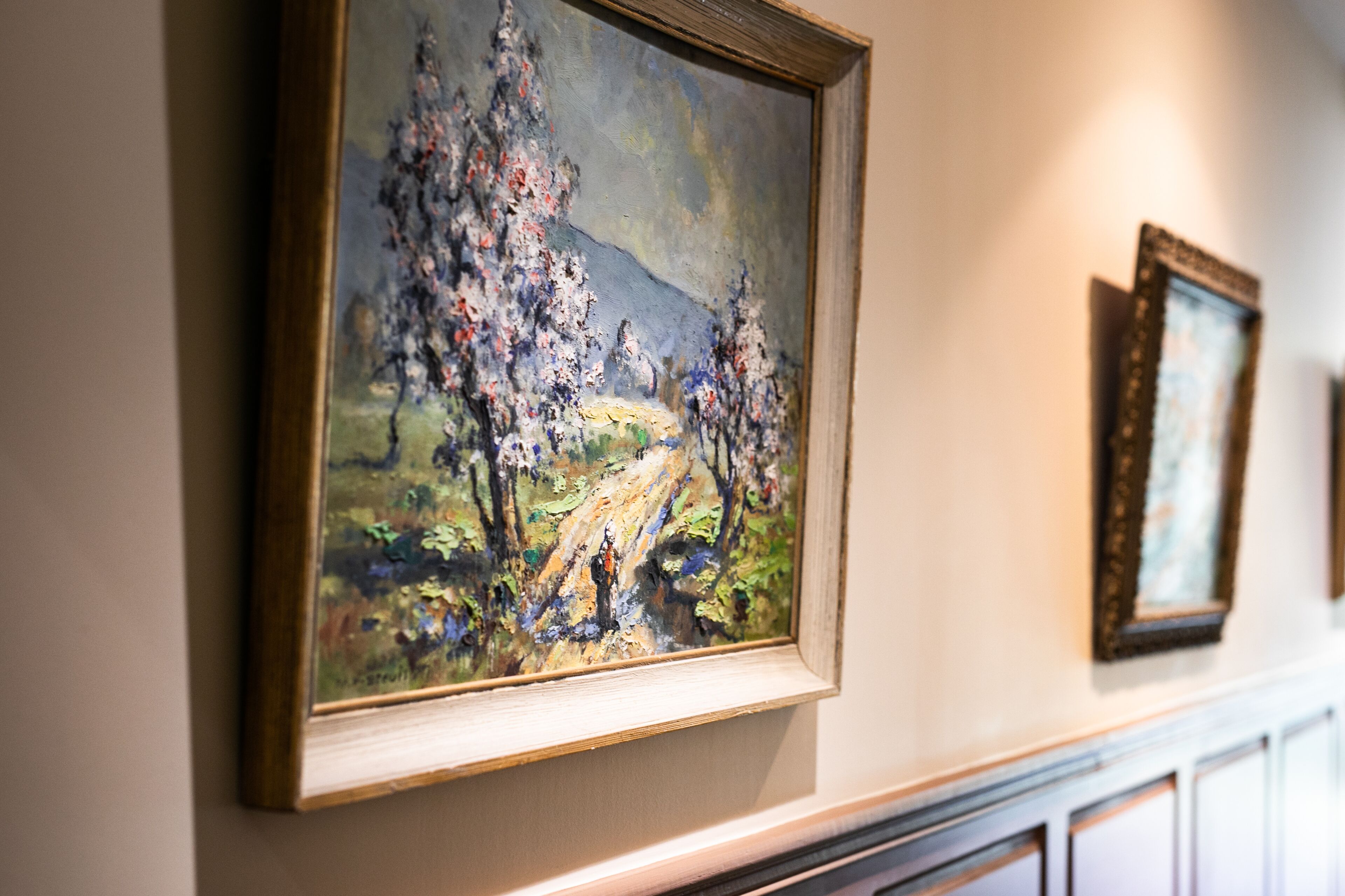 A framed painting on a wall.