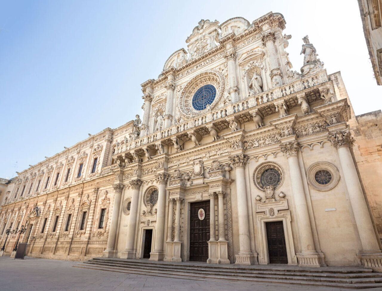 A grand, ornate building with classical architecture, featuring detailed sculptures and columns.