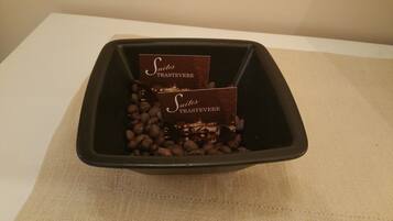 A black tray containing two chocolate truffles and a burlap cloth.