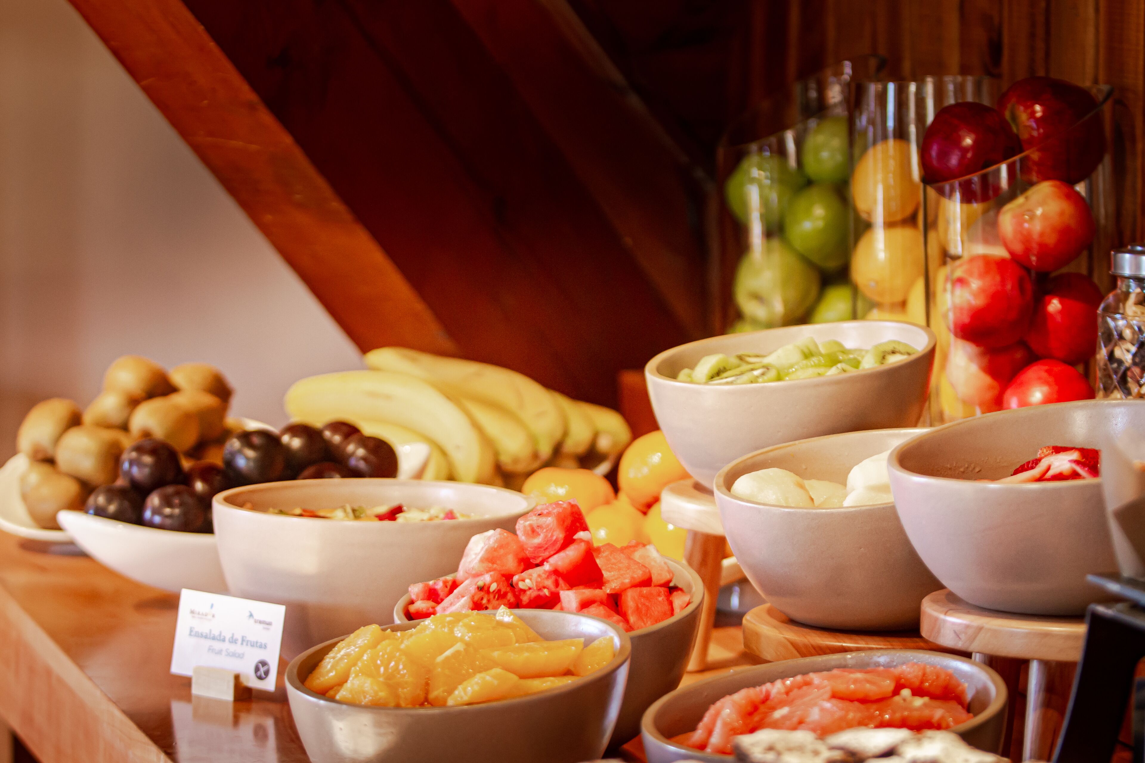 A buffet with various fruits and vegetables.